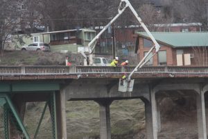 Bucket truck installing fiber on a bridge